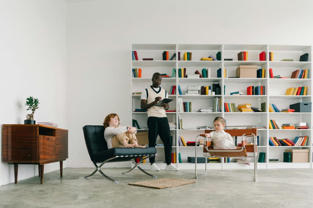 Psychologist conducts a therapy session with children in a modern library setting.